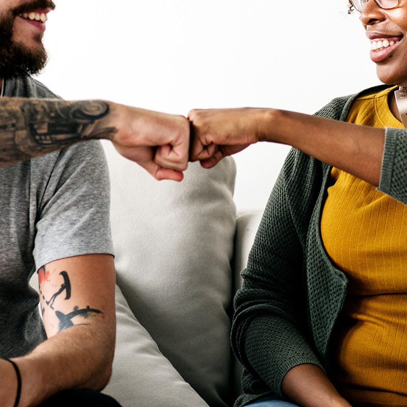 yolo-800x800-106 A counselor and a patient giving each other a fist bump.